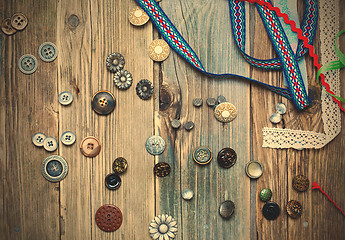 Image showing scattered vintage buttons and diverse colored band