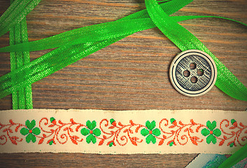 Image showing vintage embroidered band and tape with old classic button