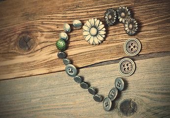 Image showing vintage buttons heart on old textured boards