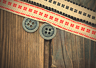 Image showing vintage ribbons with embroidered ornaments and old button