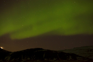 Image showing Northern lights with snowy mountains in the foreground