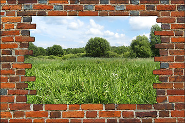 Image showing hole in the brick wall and view to summer field