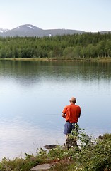 Image showing Man fishing by a lake