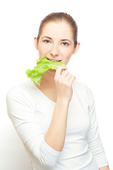 Image showing young  woman with lettuce leaf