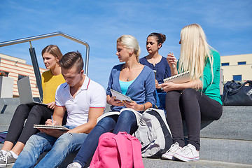 Image showing students outside sitting on steps