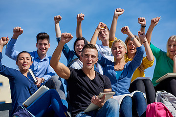 Image showing students outside sitting on steps