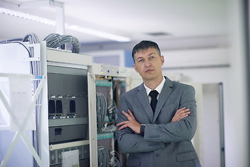 Image showing network engineer working in  server room