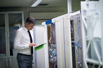 Image showing network engineer working in  server room