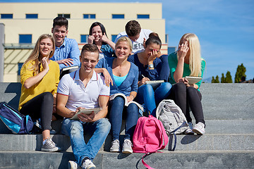 Image showing students outside sitting on steps