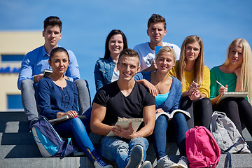 Image showing students outside sitting on steps