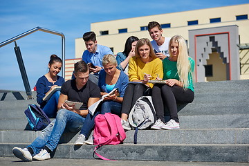 Image showing students outside sitting on steps