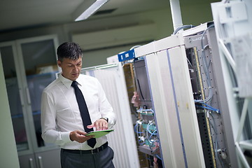 Image showing network engineer working in  server room