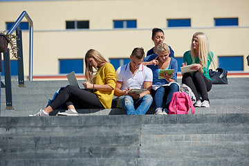 Image showing students outside sitting on steps