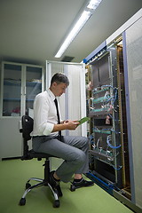 Image showing network engineer working in  server room