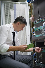 Image showing network engineer working in  server room