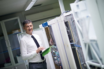 Image showing network engineer working in  server room