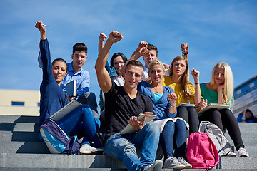 Image showing students outside sitting on steps