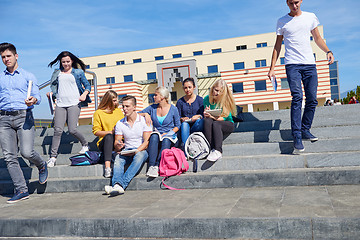 Image showing students outside sitting on steps