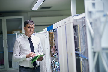 Image showing network engineer working in  server room