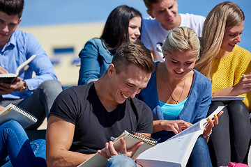 Image showing students outside sitting on steps