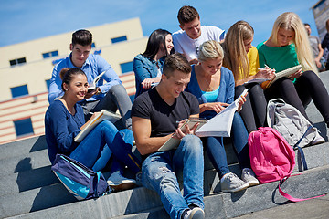 Image showing students outside sitting on steps