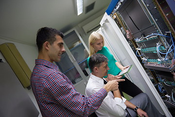 Image showing network engeneers working in network server room