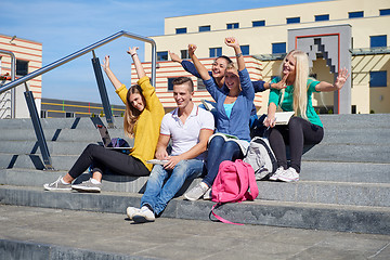 Image showing students outside sitting on steps