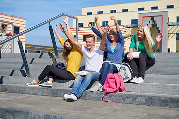 Image showing students outside sitting on steps