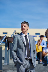 Image showing students outside sitting on steps