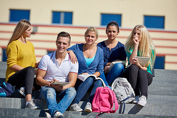 Image showing students outside sitting on steps