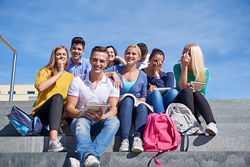 Image showing students outside sitting on steps