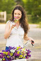 Image showing Happy girl with her bicycle