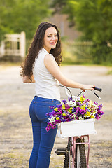 Image showing Happy girl with her bicycle