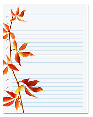 Image showing Exercise book with autumnal virginia creeper twig