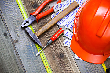 Image showing pliers, hammer, screwdriver, measuring tape, gloves and orange h