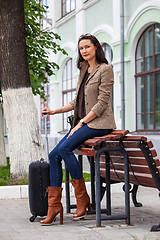 Image showing beautiful adult woman with luggage on the platform