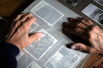 Image showing An old woman's hands on an old photo album