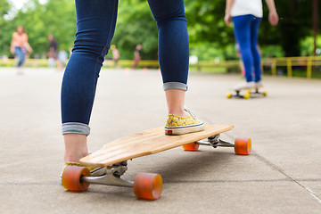 Image showing Teenage girl practicing riding long board.