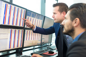 Image showing Stock traders looking at computer screens.