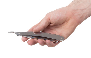 Image showing Old straight razor held by one hand
