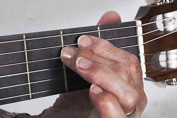 Image showing Old hand and guitar isolated