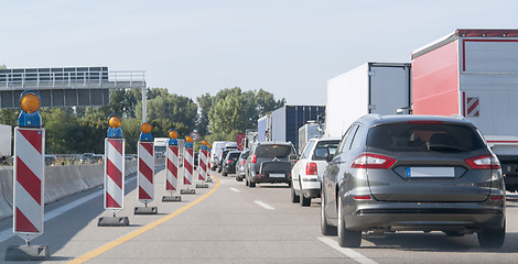 Image showing freeway with building lot and traffic jam