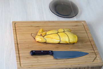 Image showing wooden board with a piece of squid