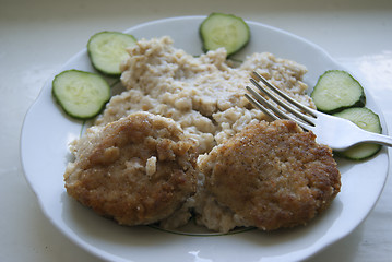 Image showing Two meatballs, with porridge and cucumbers