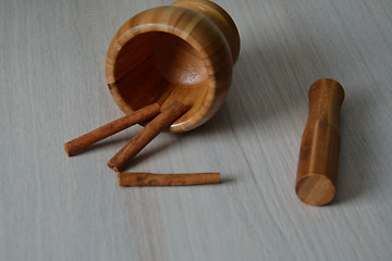 Image showing mortar and cinnamon on the table