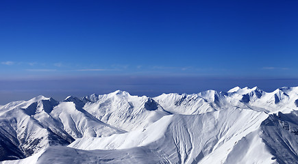 Image showing Panoramic view on off-piste slopes and multicolor blue sky at ni