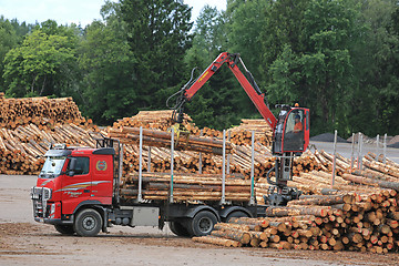 Image showing Volvo FH Truck Unloads Logs at Lumber Yard