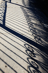 Image showing forged fence shadow on an track