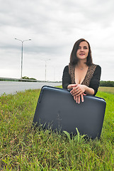 Image showing Beautiful smiling woman with suitcase