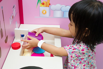 Image showing Chinese children role-playing at kitchen